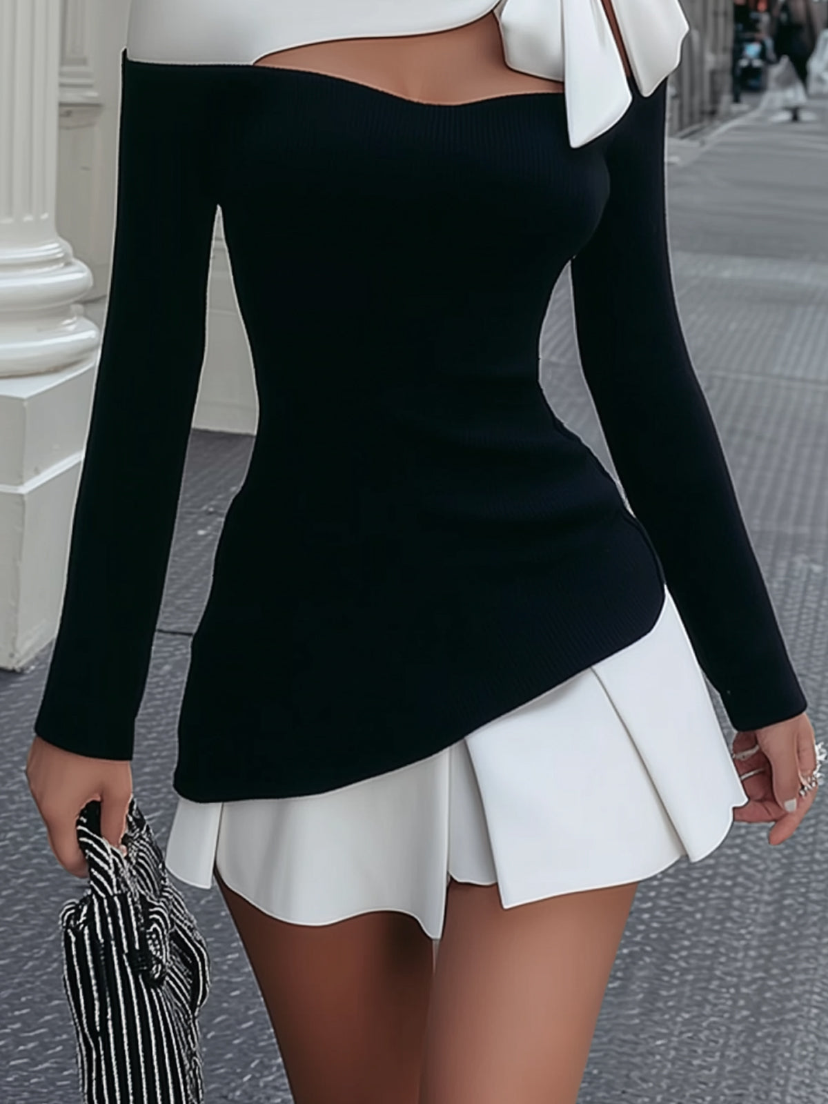 Faustine | Black and white mini dress with bow and pleated skirt