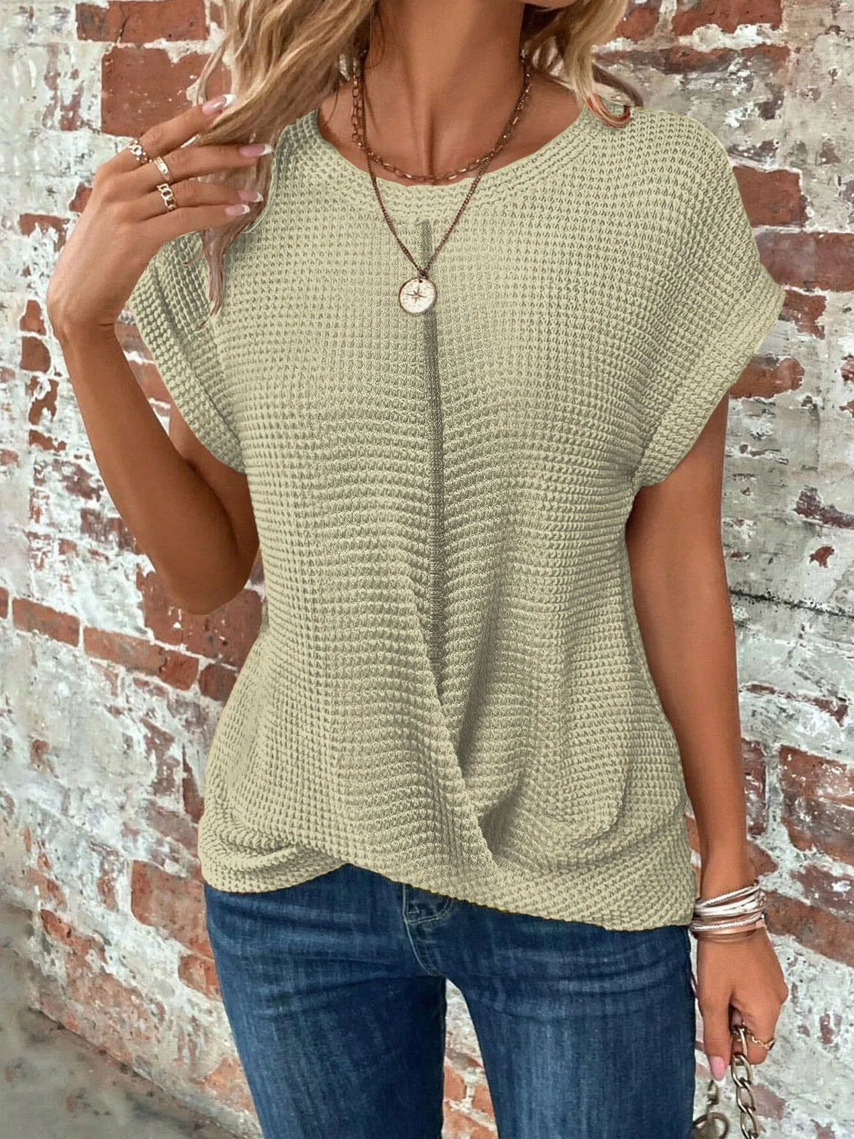 Women's knit crew neck sweater with twisted front hem