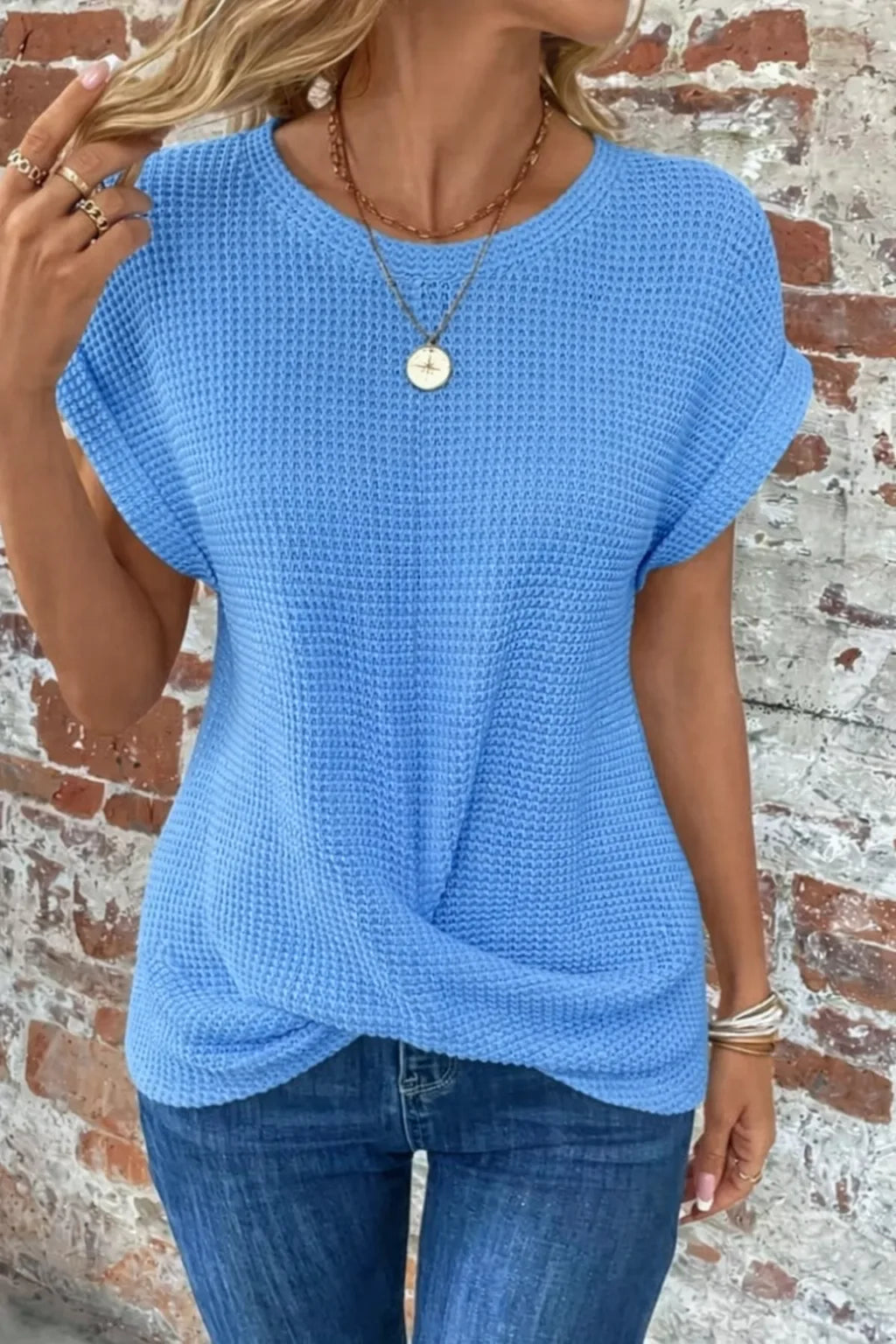 Women's knit crew neck sweater with twisted front hem